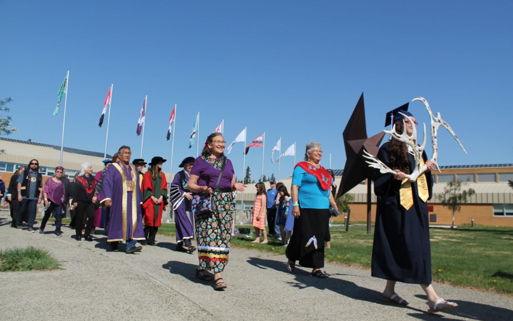 Yukon University Convocation Procession, lead by Amber Taylor-Fisher, Student Speaker, carrying the Ceremonial Antler